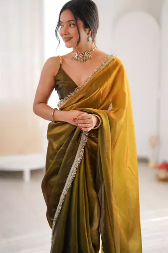 Olive tissue satin sequins saree with unstitched blouse piece.