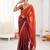 Rust tissue satin sequins saree with unstitched blouse piece.