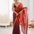 Rust tissue satin sequins saree with unstitched blouse piece.