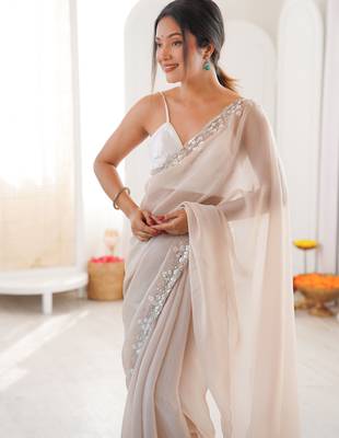 Cream chiffon embellished saree with unstitched blouse piece. 4