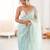 Sea green chiffon embellished saree with unstitched blouse piece.