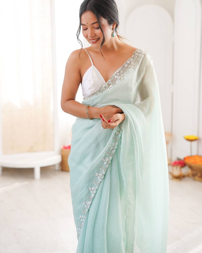 Sea green chiffon embellished saree with unstitched blouse piece.