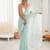 Sea green chiffon embellished saree with unstitched blouse piece.