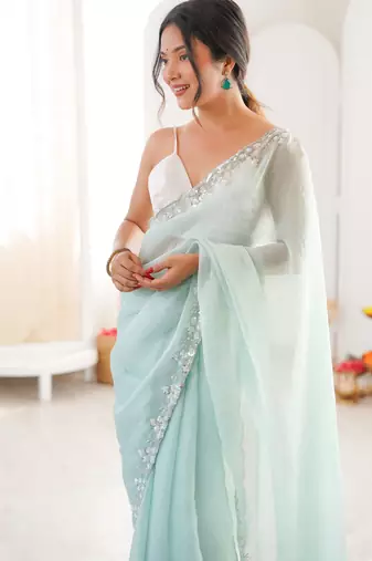 Sea green chiffon embellished saree with unstitched blouse piece.