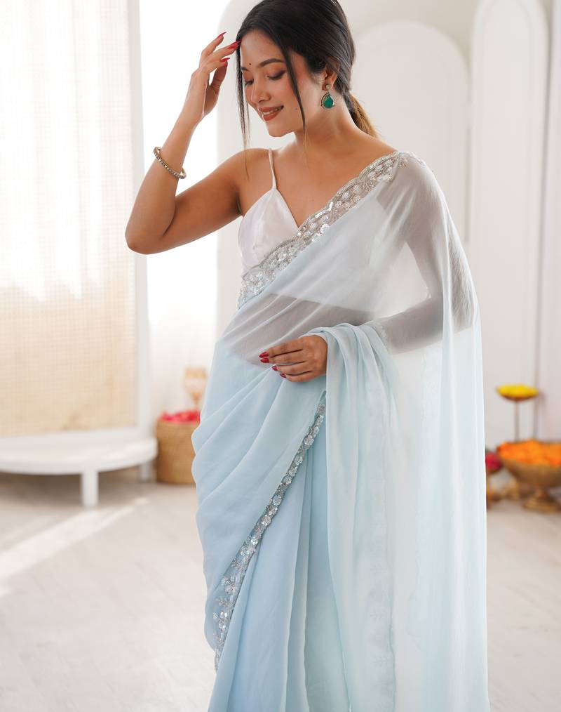 Sky blue chiffon embellished saree with unstitched blouse piece.