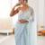 Sky blue chiffon embellished saree with unstitched blouse piece.
