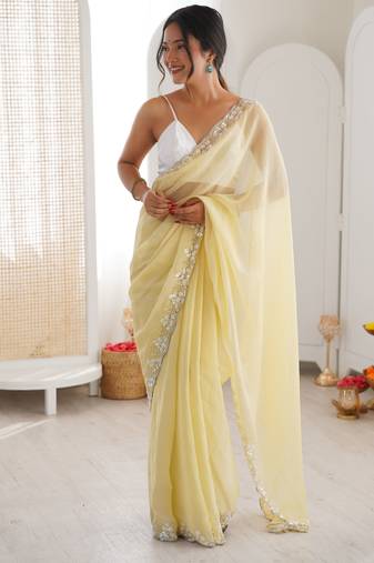 Yellow chiffon embellished saree with unstitched blouse piece.