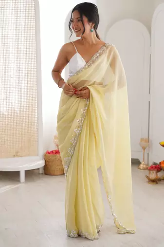 Yellow chiffon embellished saree with unstitched blouse piece.