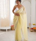 Yellow chiffon embellished saree with unstitched blouse piece.