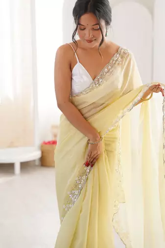 Yellow chiffon embellished saree with unstitched blouse piece.