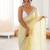 Yellow chiffon embellished saree with unstitched blouse piece.