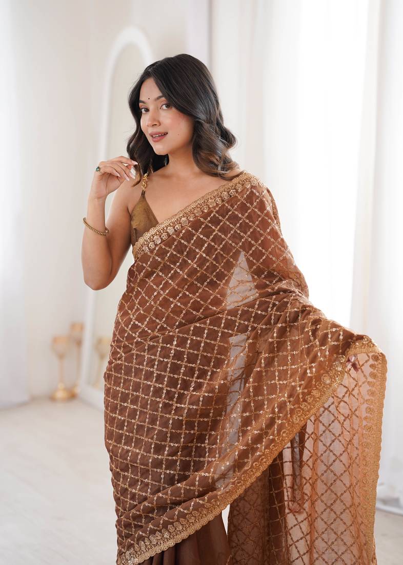 Brown chiffon embroidered saree with unstitched blouse piece.