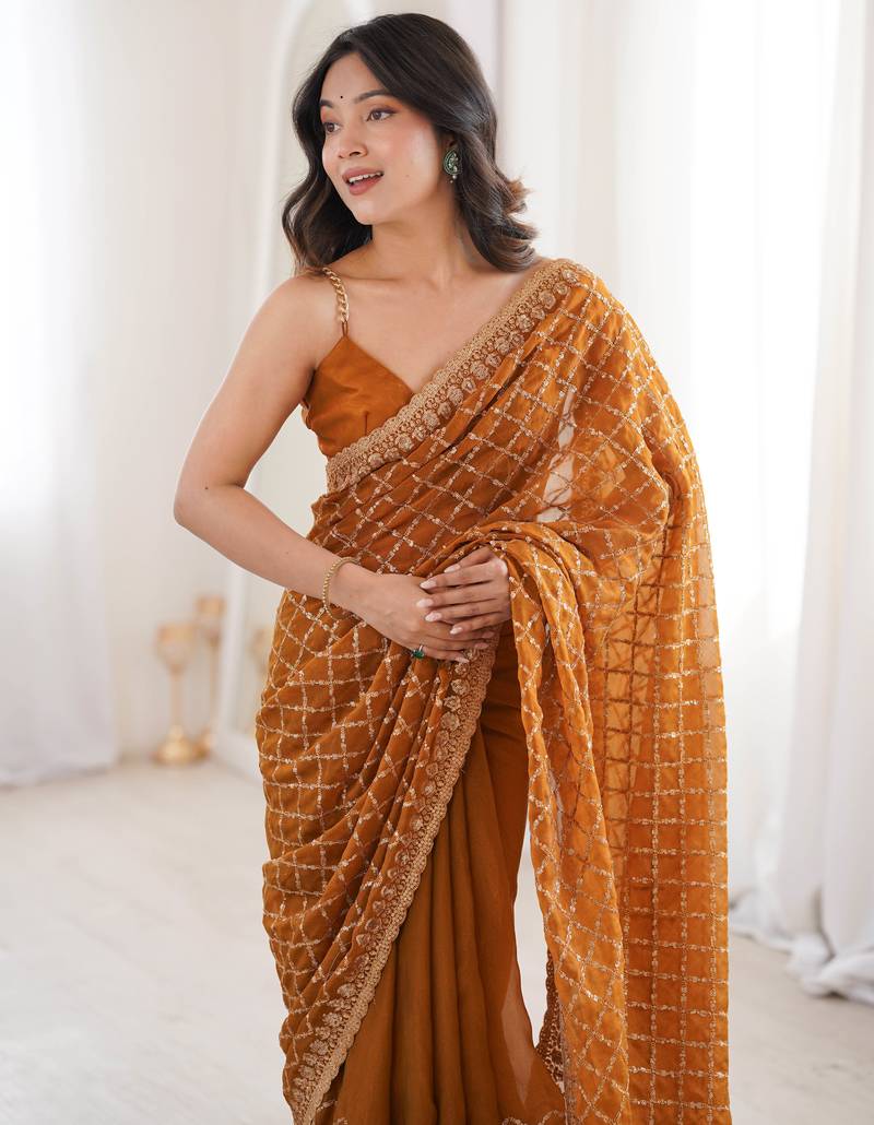 Mustard chiffon embroidered saree with unstitched blouse piece.
