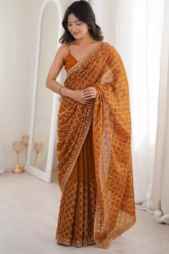 Mustard chiffon embroidered saree with unstitched blouse piece.