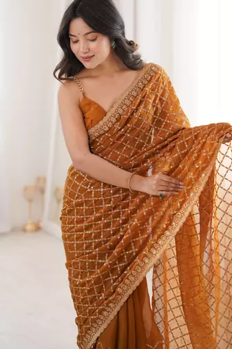 Mustard chiffon embroidered saree with unstitched blouse piece.