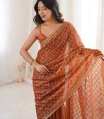 Orange chiffon embroidered saree with unstitched blouse piece.