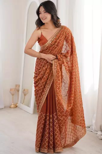 Orange chiffon embroidered saree with unstitched blouse piece.