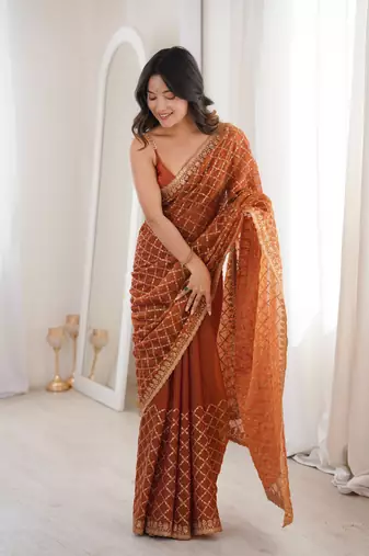 Orange chiffon embroidered saree with unstitched blouse piece.