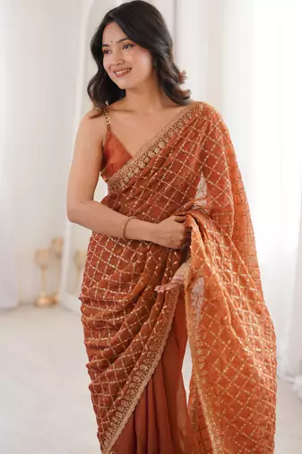 Orange chiffon embroidered saree with unstitched blouse piece.