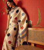 Cream satin printed saree with unstitched blouse piece.