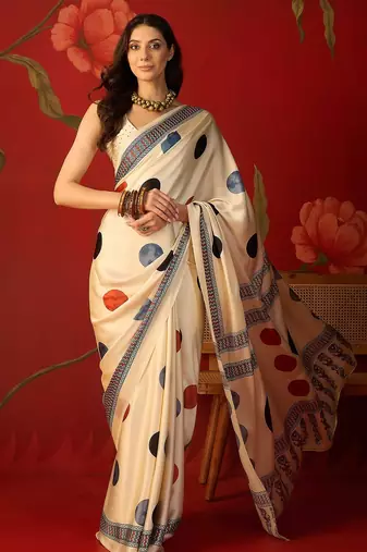 Cream satin printed saree with unstitched blouse piece.