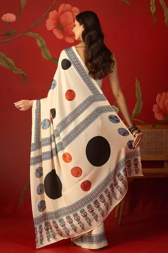 Cream satin printed saree with unstitched blouse piece.