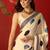 Cream satin printed saree with unstitched blouse piece.
