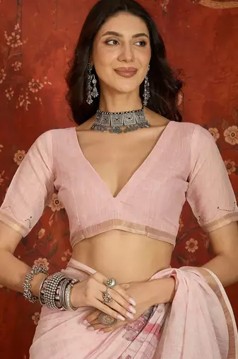 Baby pink linen embellished saree with unstitched blouse piece.