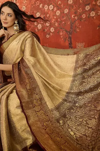 cream kanjeevaram silk blend woven design saree with unstitched blouse piece.