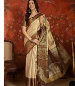 cream kanjeevaram silk blend woven design saree with unstitched blouse piece.