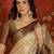 cream kanjeevaram silk blend woven design saree with unstitched blouse piece.