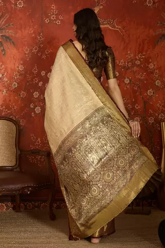 cream kanjeevaram silk blend woven design saree with unstitched blouse piece.