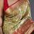 green kanjeevaram silk blend zari woven saree with unstitched blouse piece.