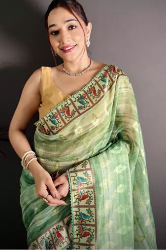 green slub cotton blend printed saree with unstitched blouse piece.