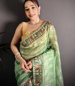 green slub cotton blend printed saree with unstitched blouse piece.