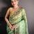 green slub cotton blend printed saree with unstitched blouse piece.