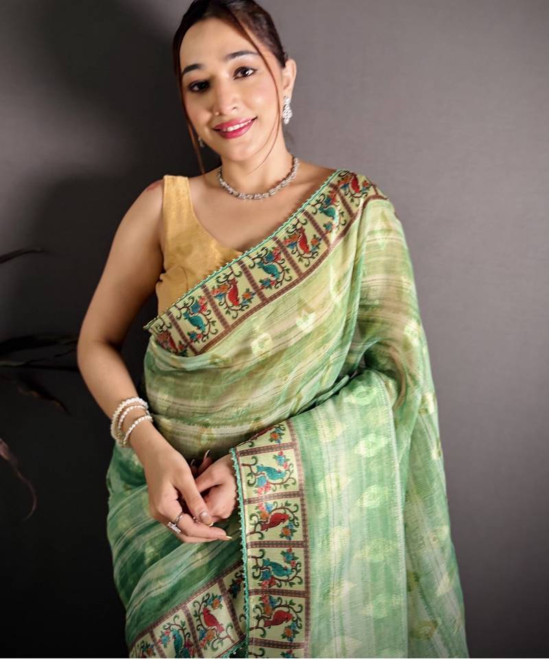 green slub cotton blend printed saree with unstitched blouse piece.