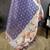 purple premium cotton blend printed saree with unstitched blouse piece.
