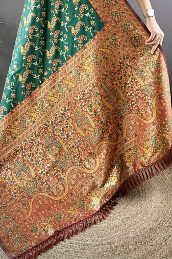 green satin silk blend zari woven saree with unstitched blouse piece.