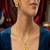 Gold plated sunburst jewelry set: floral pendant necklace, black stone earrings