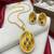 Gold plated sunburst jewelry set: floral pendant necklace, black stone earrings