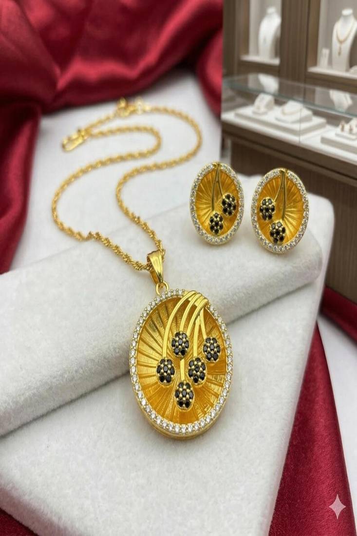 Gold plated sunburst jewelry set: floral pendant necklace, black stone earrings