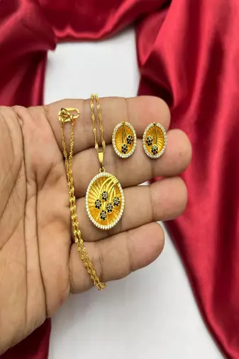 Gold plated sunburst jewelry set: floral pendant necklace, black stone earrings