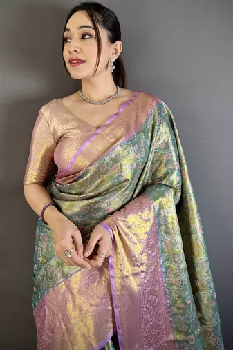 green kanjeevaram silk blend zari woven saree with unstitched blouse piece.