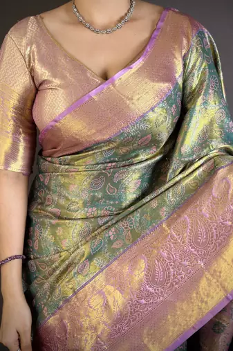 green kanjeevaram silk blend zari woven saree with unstitched blouse piece.
