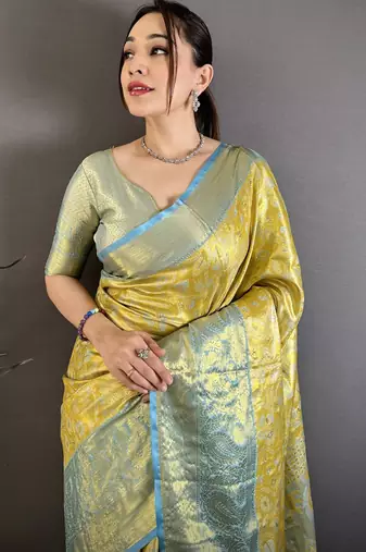 yellow kanjeevaram silk blend zari woven saree with unstitched blouse piece.