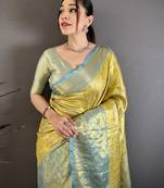 yellow kanjeevaram silk blend zari woven saree with unstitched blouse piece.