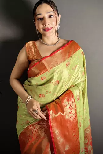 green kanjeevaram silk blend zari woven saree with unstitched blouse piece.