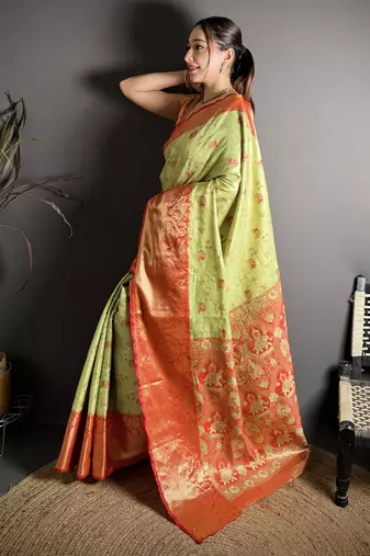green kanjeevaram silk blend zari woven saree with unstitched blouse piece.