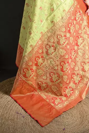 green kanjeevaram silk blend zari woven saree with unstitched blouse piece.